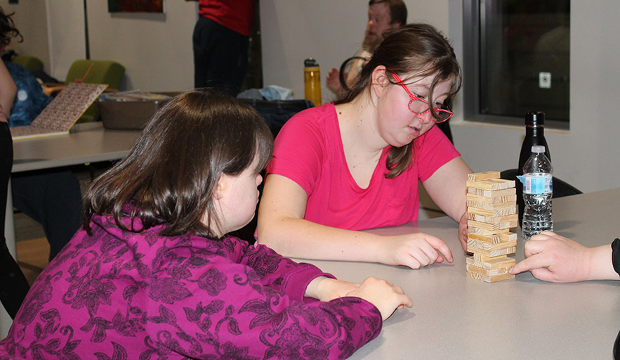 Two female Therapeutic Rec participants enjoy program participation through the use of games