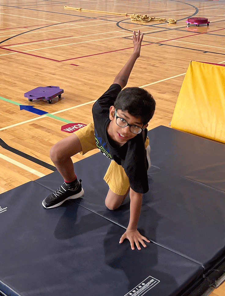 A child leaps on the mats at Abilities Centre's Obstacle course program