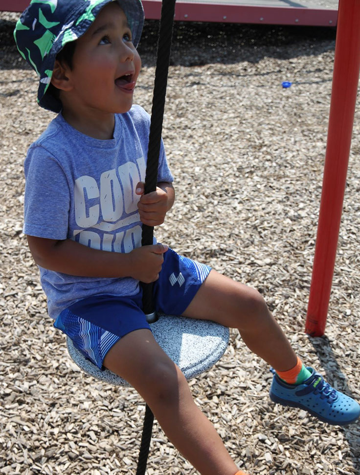 a child on a swing at the park 