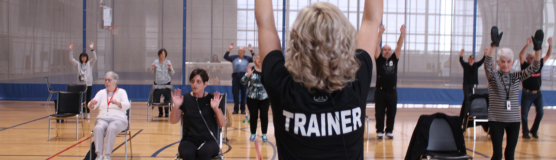 Trainer leads respiratory and cardiac participants through a range of physical motions with variations of movement