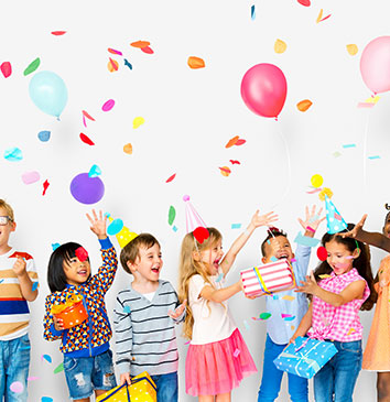 Children celebrating with balloons and colourful confetti