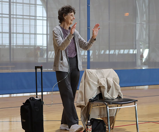 a participant doing standing warm up during a post rehab program