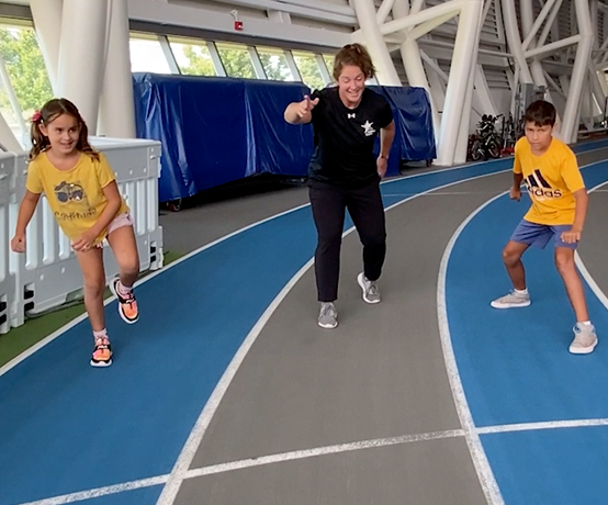 Kids and instructor playing on the track