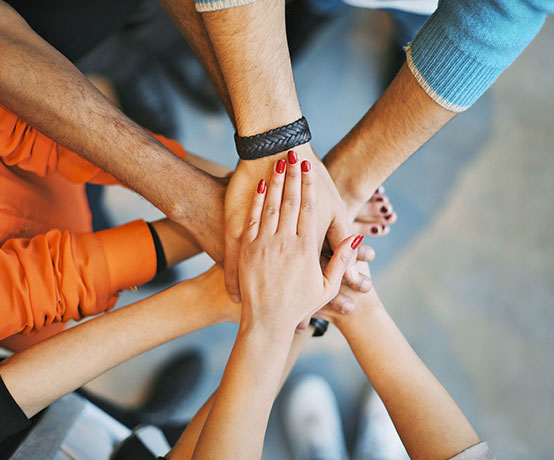 hands in a team huddle