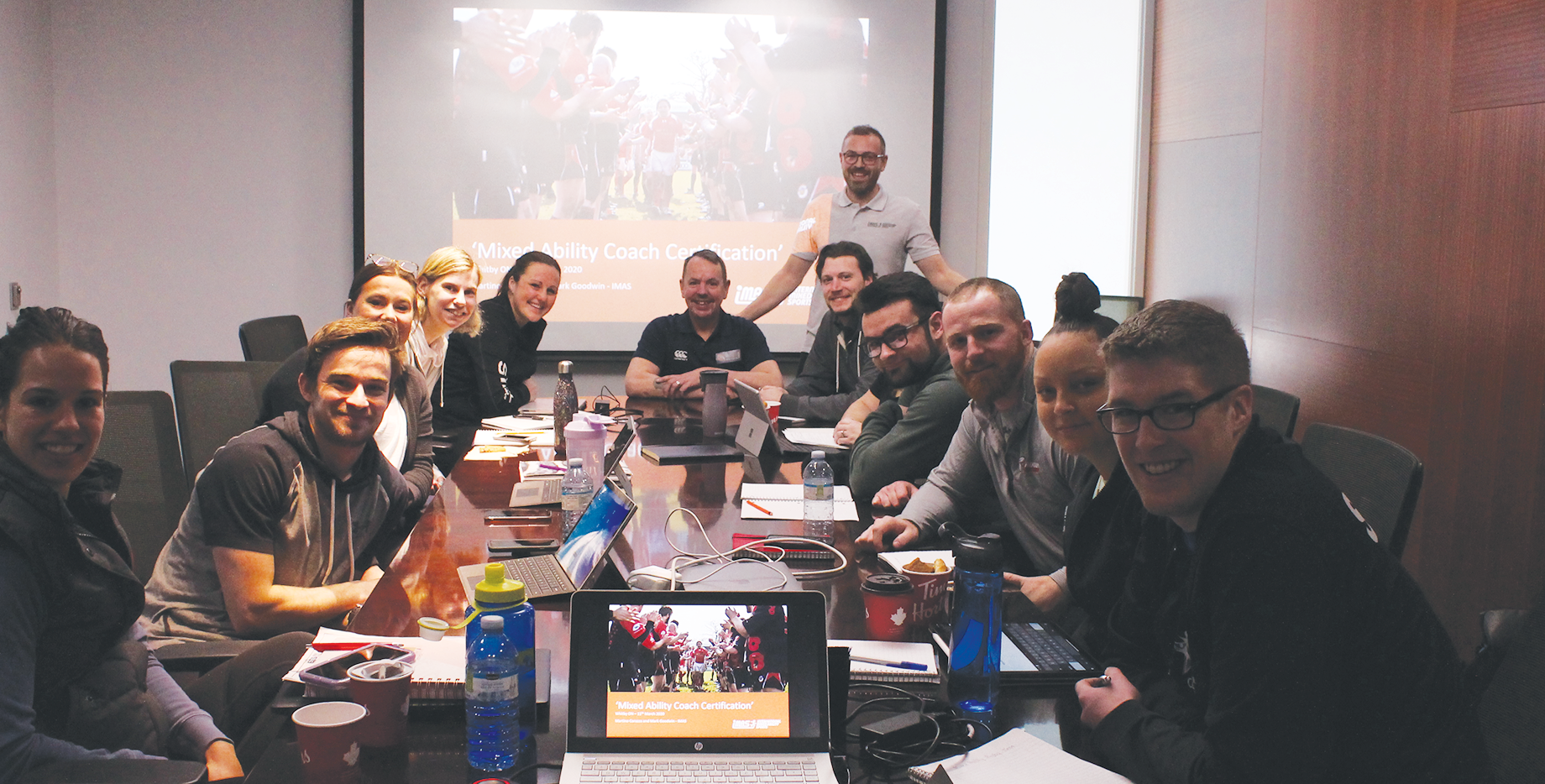 A group of diverse Abilities Centre employees and volunteers discussing program development 