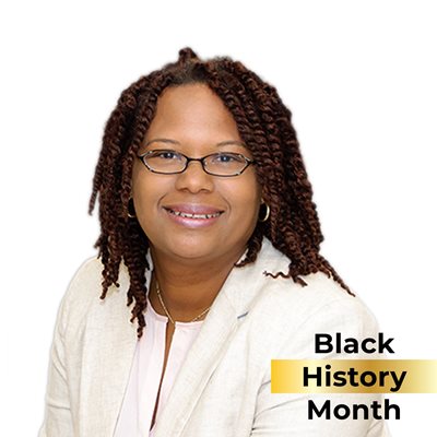 headshot of Hermia smiling.white background. Black History Month is written. Black History Month is written above.