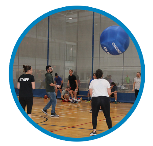 A group of coaches play Kin ball on Abilities Centre Court