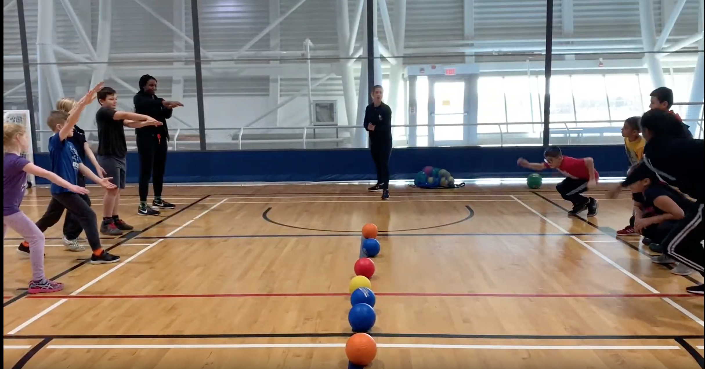 Children and youth of all ages participate in a game with balls on court