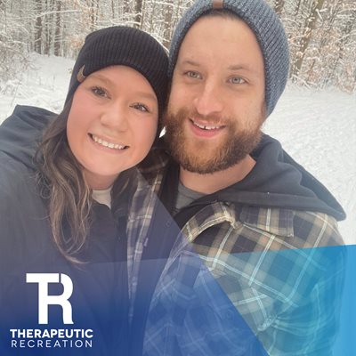 Kelsey and her partner walking outside on a snowy trail