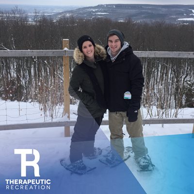 Image of Adam and wife outdoors. TR logo is in bottom left.