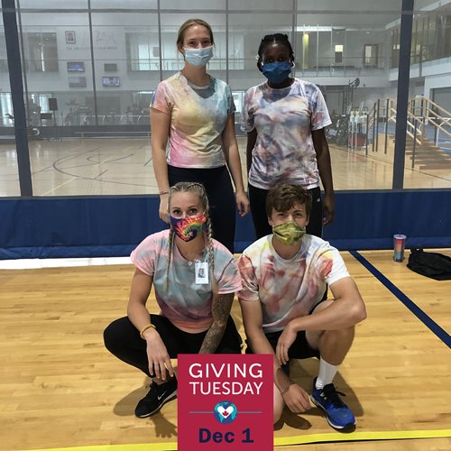 Sport and Rec staff post for a photo while wearing masks inside the Fieldhouse