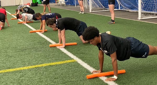 ASAD Students in plank position on the indoor field