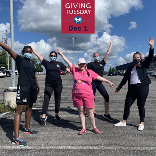 Thrive participants and staff pose in the parking lot