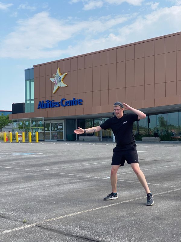 Clay performs a dance in the parking lot of Abilities Centre