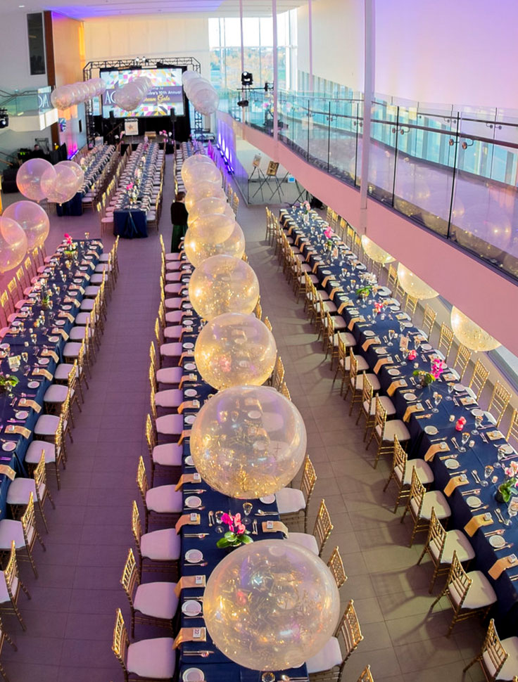 An overhead view of beautifully decorated tables in the atrium.