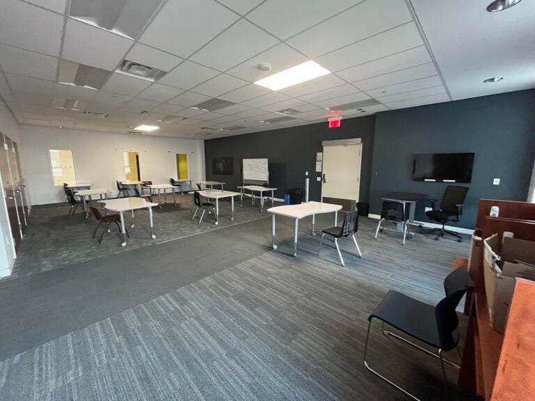 A classroom space with desks and chairs.