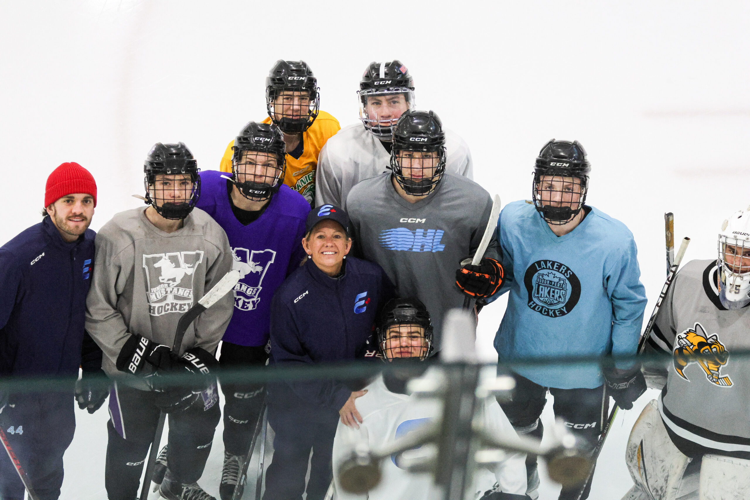 Kathy McLlwain poses wiht A.S.A.D. hockey students.