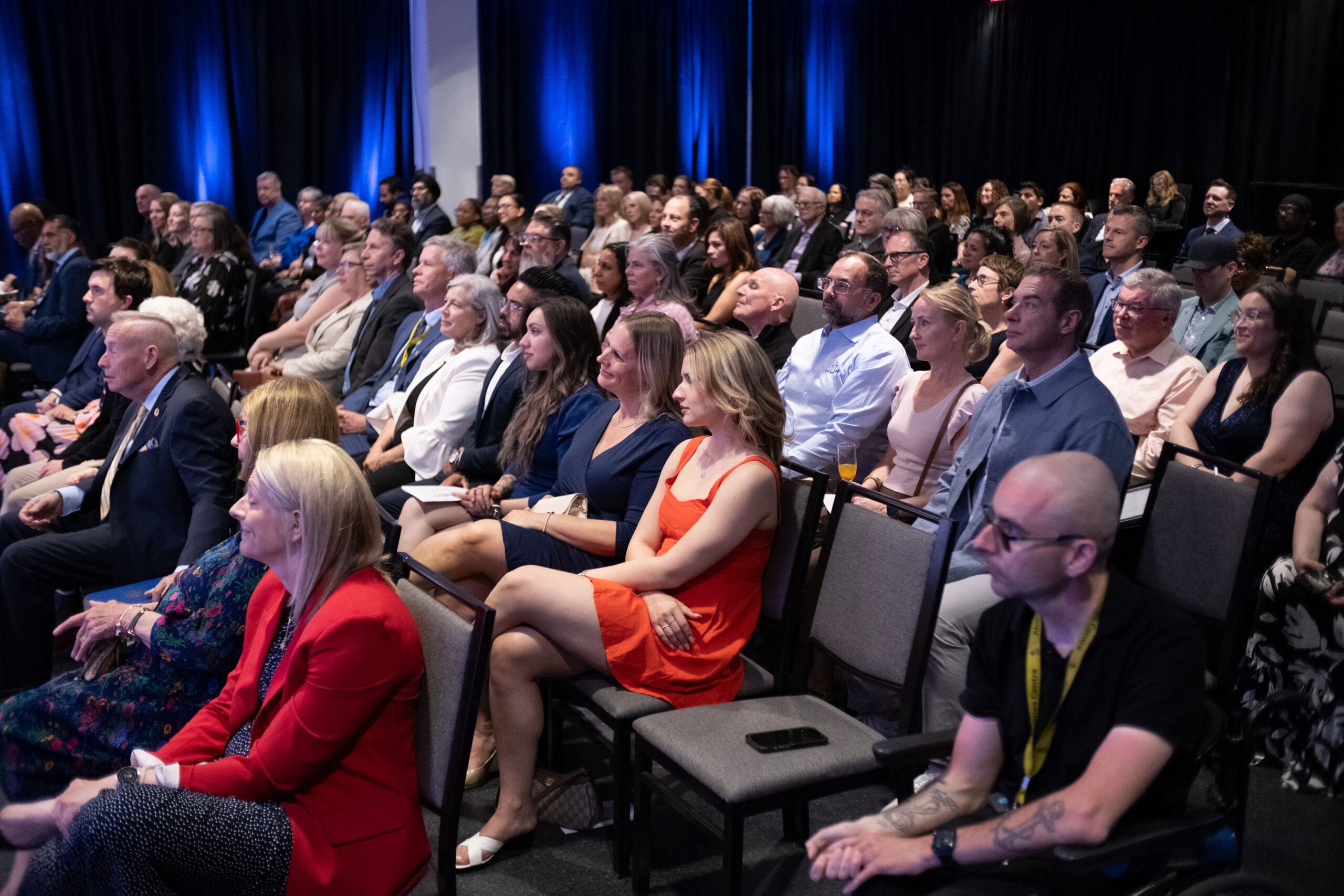People sitting in rows during an event in the C.A.A. Community Auditorium.