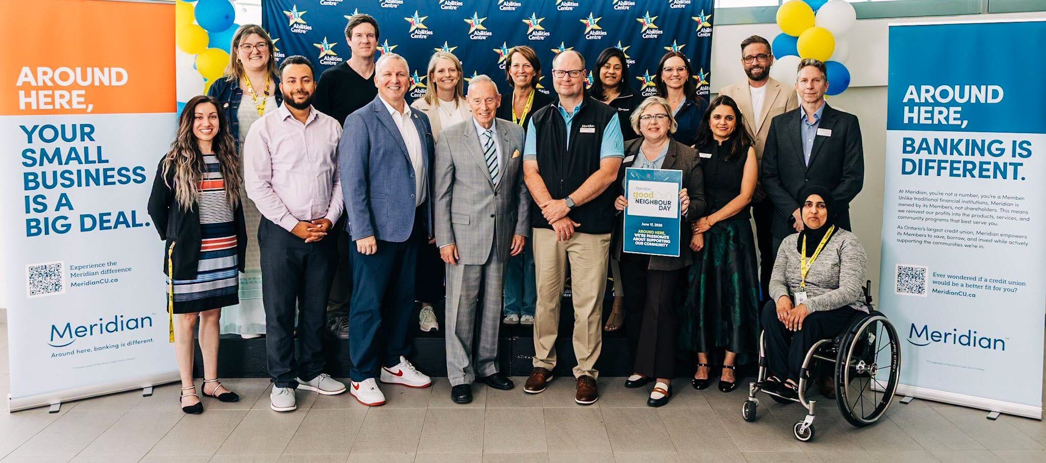 Abilities Centre and Meridian Credit Union staff pose together.