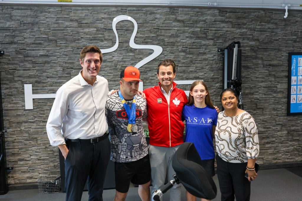 The Honourable Adam van Koeverden and M.P.s Ryan Turnbull and Juanita Nathan pose with A.S.A.D. student Airlie Downie-Back and Special Olympian Alexander Bevacqua.