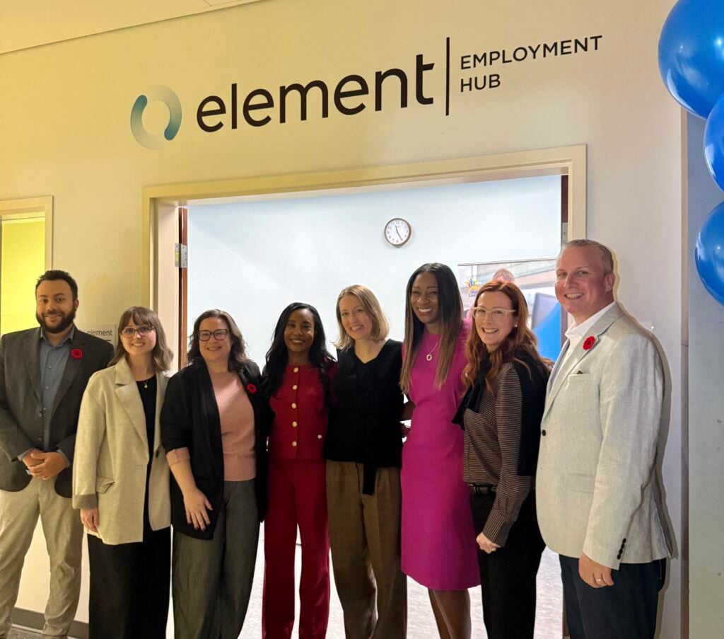 Members of Abilities Centre's team and Element Fleet Management's team post at the doorway of the new Element Employment Hub,